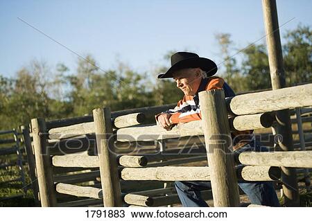 Rancher leaning on a corral View Large Photo Image Stock Image - Rancher leaning on a corral. Fotosearch