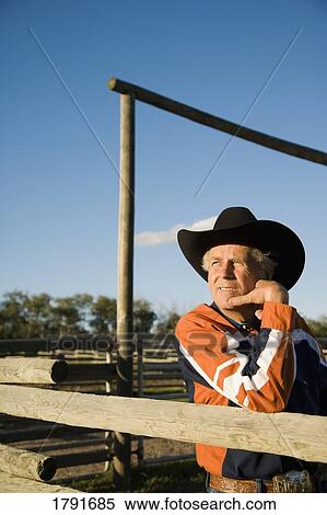 Rancher leaning on a corral View Large Photo Image Stock Photography - Rancher leaning on a corral. Fotosearch