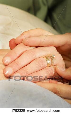 Stock Photo - Resting hands on another persons hands. Fotosearch