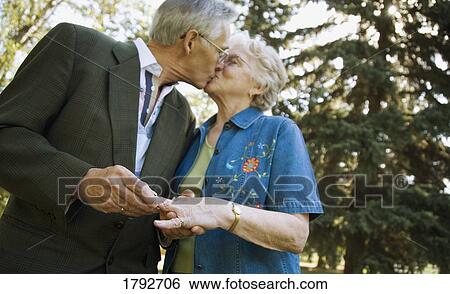 Stock Photograph - Senior man and woman kissing . Fotosearch