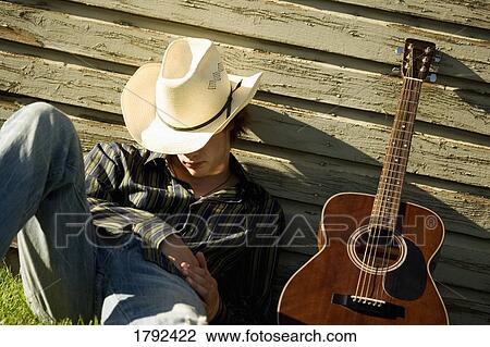 Stock Image - Sleeping cowboy with guitar. Fotosearch