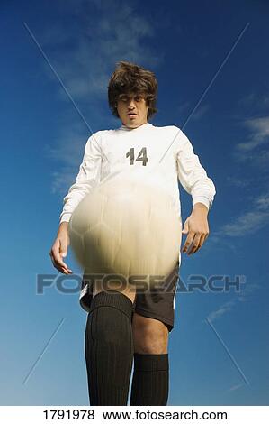 Stock Photo - Soccer player kicking ball. Fotosearch