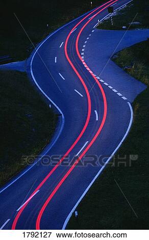 Streaking car tail lights on road View Large Photo Image Stock Photo - Streaking car tail lights on road. Fotosearch