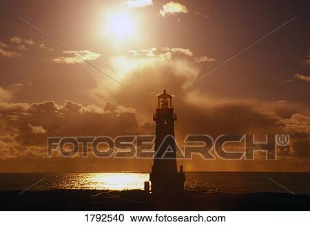 Stock Image - Sunset at Yaquina Head Lighthouse. Fotosearch