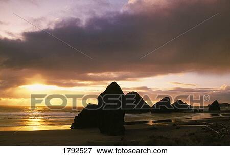 Stock Photo - Sunset over beach. Fotosearch