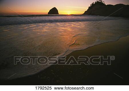 Stock Photography - Sunset over Hay Stack Rock along the Oregon Coast. Fotosearch