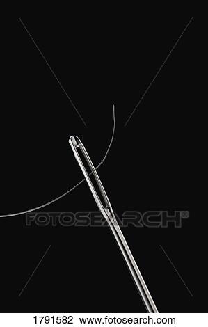 Thread through eye of needle View Large Photo Image Stock Image - Thread through eye of needle. Fotosearch