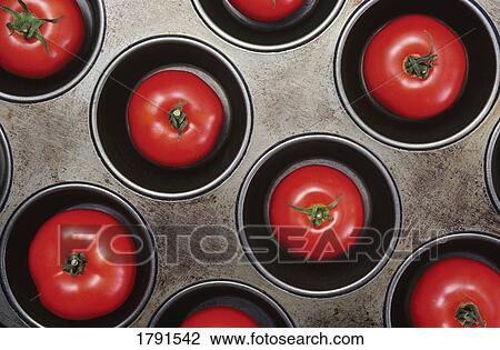 Stock Image - Tomatoes in muffin pan. Fotosearch