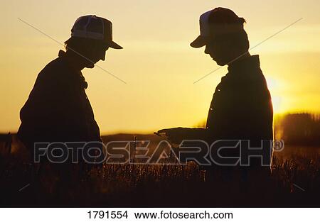 Two farmers in field View Large Photo Image Picture - Two farmers in field. Fotosearch