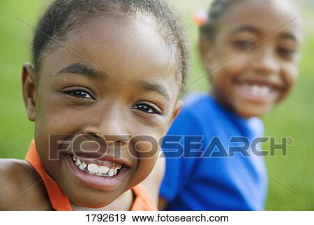 Two girls smiling View Large Photo Image Stock Photo - Two girls smiling. Fotosearch