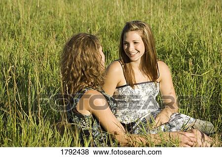 Stock Photo - Two women talking in field. Fotosearch