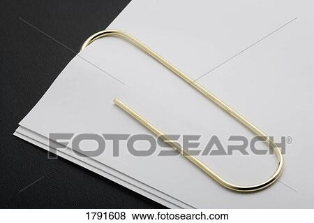 White paper clipped with gold paper clip View Large Photo Image Stock Photo - White paper clipped with gold paper clip. Fotosearch