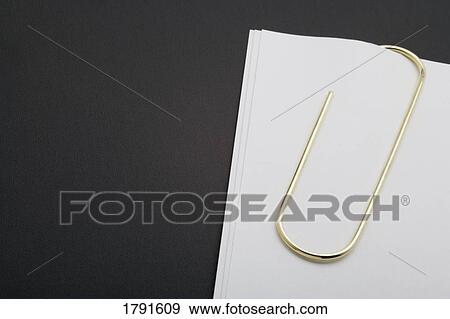 White paper clipped with gold paper clip View Large Photo Image Stock Photo - White paper clipped with gold paper clip. Fotosearch