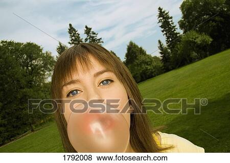 Woman blowing bubblegum View Large Photo Image Stock Photo - Woman blowing bubblegum. Fotosearch