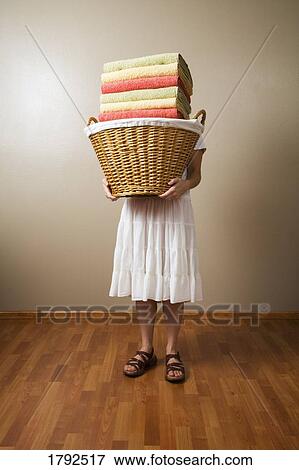 Woman carrying a laundry basket View Large Photo Image Stock Photo - Woman carrying a laundry basket. Fotosearch