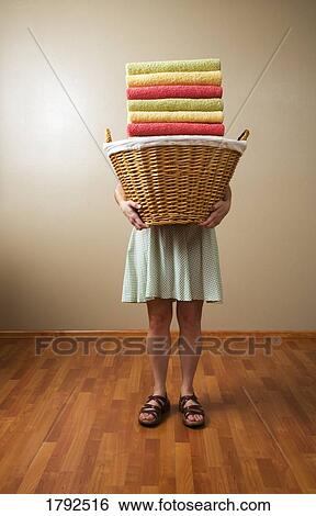 Stock Photograph - Woman carrying a laundry basket. Fotosearch