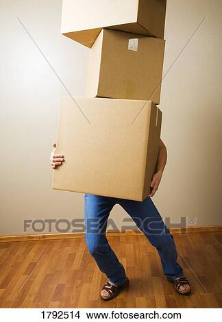 Woman carrying heavy boxes View Large Photo Image Picture - Woman carrying heavy boxes. Fotosearch
