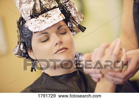 Stock Photo - Woman having her hair dyed. Fotosearch