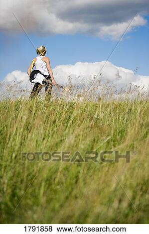 Stock Photo - Woman holding an electric guitar. Fotosearch