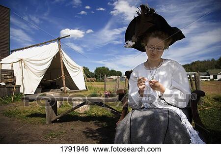Woman in period costume crocheting View Large Photo Image Stock Photograph - Woman in period costume crocheting. Fotosearch