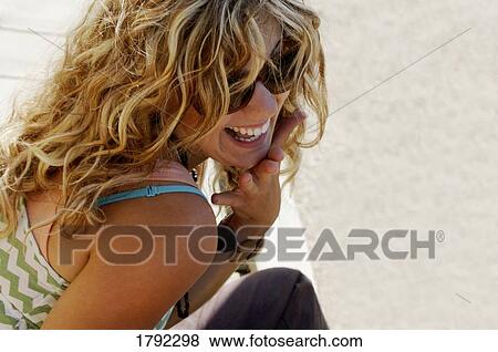 Woman in sunglasses laughing View Large Photo Image Stock Photo - Woman in sunglasses laughing. Fotosearch