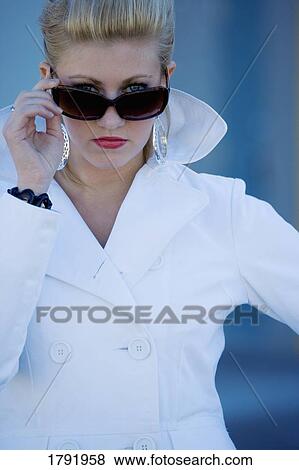 Woman looking over sunglasses View Large Photo Image Stock Photo - Woman looking over sunglasses. Fotosearch