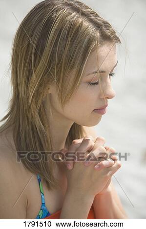 Woman praying at beach View Large Photo Image Stock Image - Woman praying at beach. Fotosearch