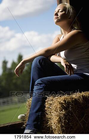 Woman sitting in a barn loft View Large Photo Image Picture - Woman sitting in a barn loft. Fotosearch
