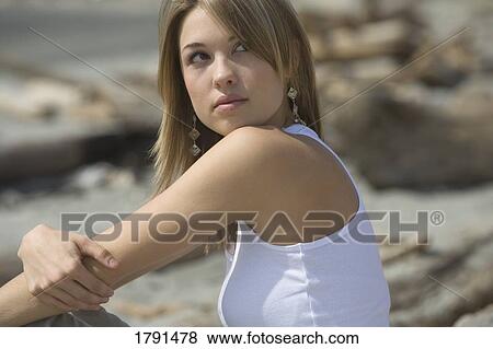 Woman sitting on beach View Large Photo Image Stock Photo - Woman sitting on beach. Fotosearch