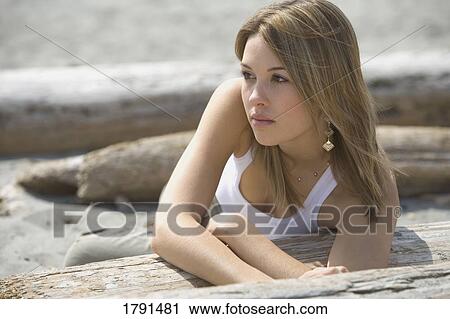 Woman sitting on the beach View Large Photo Image Stock Image - Woman sitting on the beach. Fotosearch