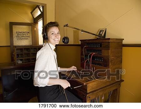 Woman working at telephone switchboard View Large Photo Image Stock Image - Woman working at telephone switchboard. Fotosearch