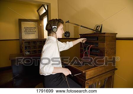 Woman working at telephone switchboard View Large Photo Image Stock Photo - Woman working at telephone switchboard. Fotosearch