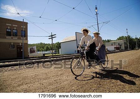 Women riding a tandem bicycle View Large Photo Image Stock Photograph - Women riding a tandem bicycle. Fotosearch