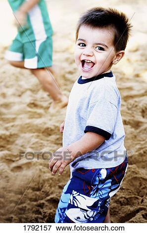 Young boy playing in sand View Large Photo Image Stock Photo - Young boy playing in sand. Fotosearch