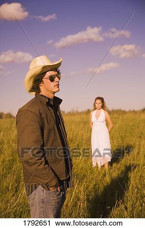 Young couple in field View Large Photo Image Stock Image - Young couple in field. Fotosearch