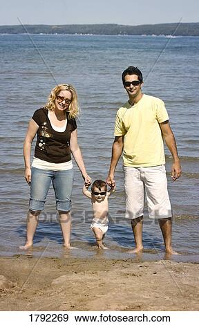 Young family on beach View Large Photo Image Stock Photo - Young family on beach. Fotosearch