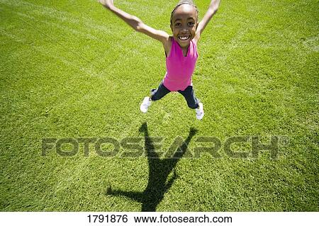 Young girl doing jumping jacks View Large Photo Image Stock Photograph - Young girl doing jumping jacks. Fotosearch