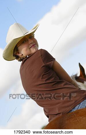 Young girl riding horse View Large Photo Image Stock Image - Young girl riding horse. Fotosearch