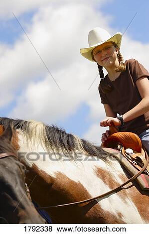 Young girl riding horse View Large Photo Image Stock Photo - Young girl riding horse. Fotosearch