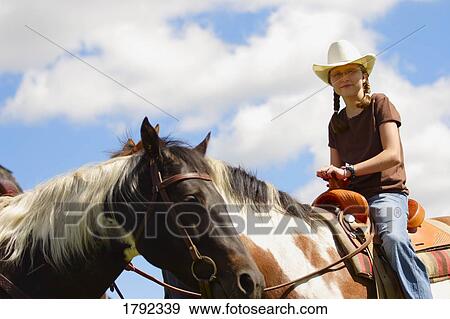 Young girl riding horse View Large Photo Image Stock Photo - Young girl riding horse. Fotosearch