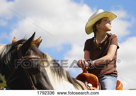 Young girl riding horse View Large Photo Image Stock Photograph - Young girl riding horse. Fotosearch