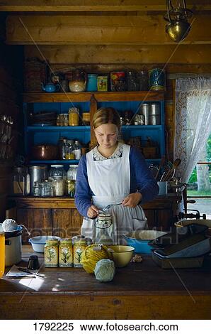 Stock Photography - Young lady baking in the 1800's. Fotosearch