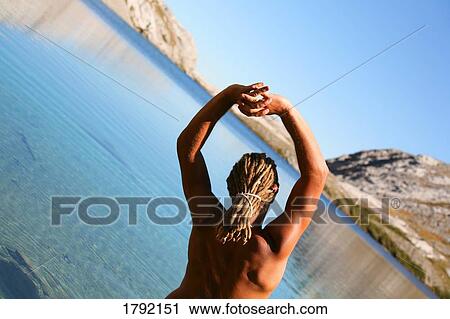 Young man stretching View Large Photo Image Stock Image - Young man stretching. Fotosearch
