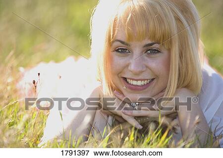 Young woman smiling View Large Photo Image Stock Photo - Young woman smiling. Fotosearch
