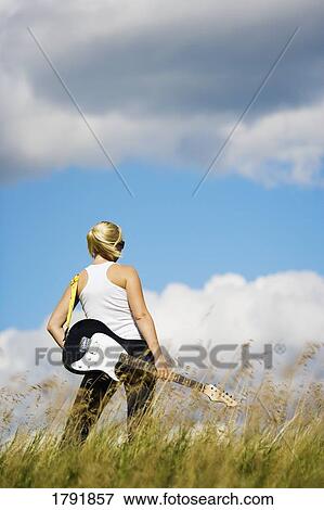 Young woman with electric guitar View Large Photo Image Stock Photo - Young woman with electric guitar. Fotosearch