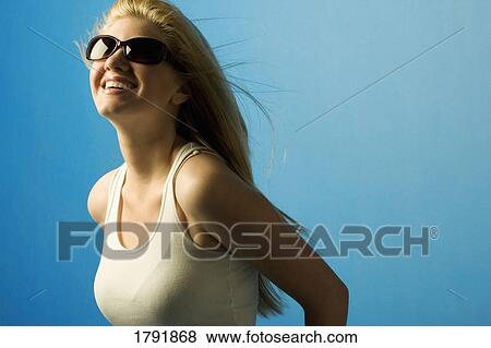 Stock Photo - Young woman with sunglasses. Fotosearch