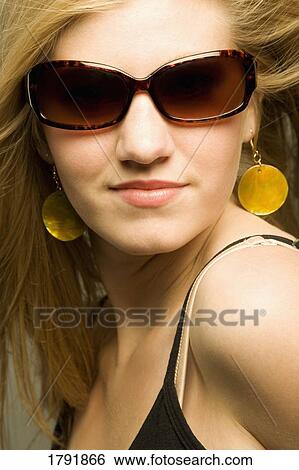Stock Photograph - Young woman with sunglasses. Fotosearch