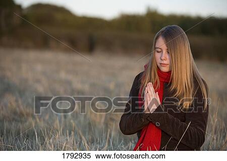 A teenage girl praying View Large Photo Image Stock Photography - A teenage girl praying. Fotosearch