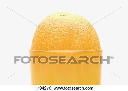 Stock Photograph - An orange and orange juice. Fotosearch