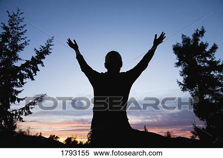Stock Photography - Arms raised towards the sky. Fotosearch